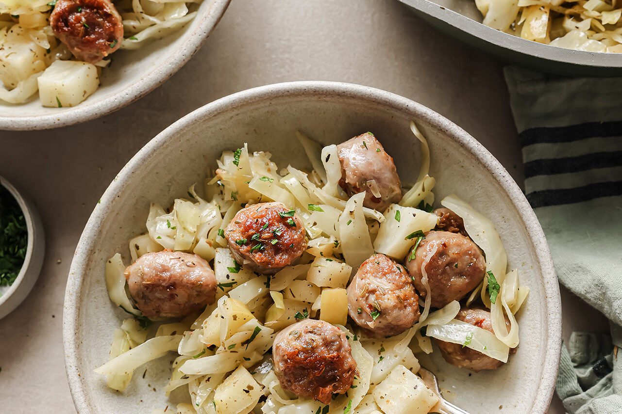 A bowl of cabbage and sausage breakfast skillet after being served.