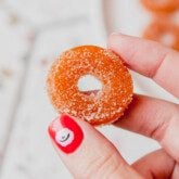 Protein peach ring being held up.