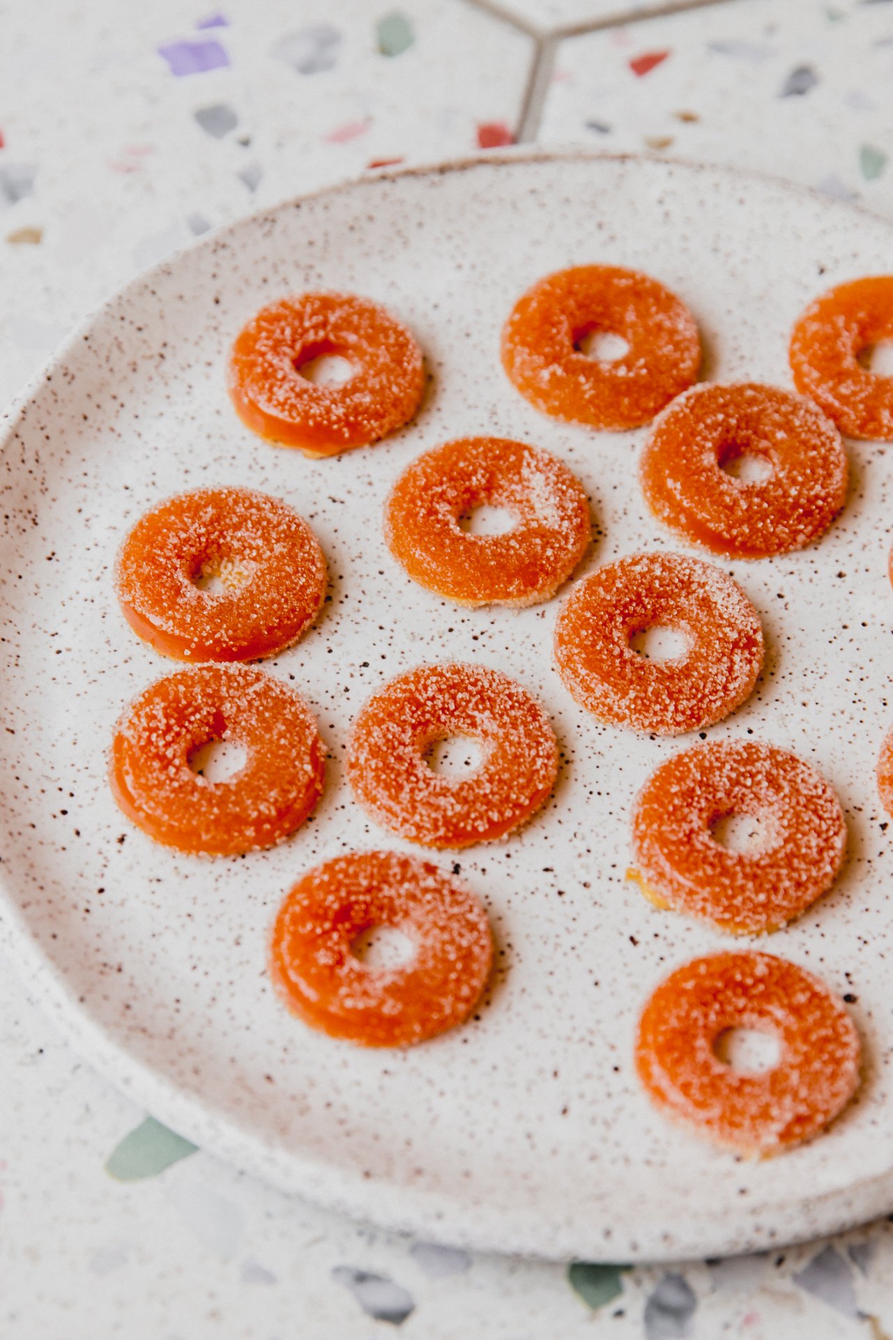 Protein peach ring gummies on a plate.