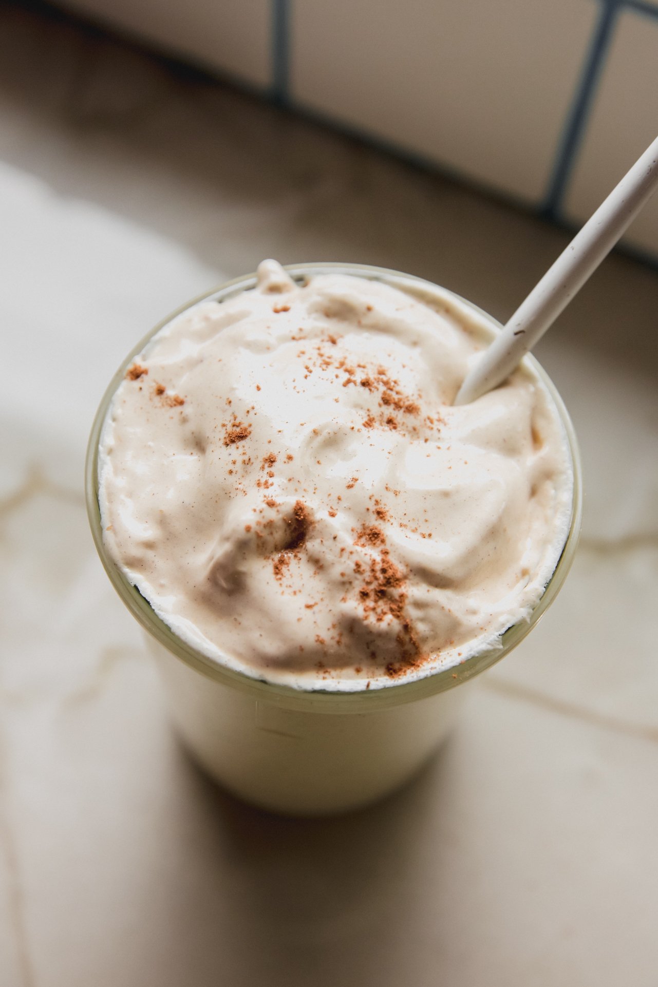A glass cup filled with pumpkin spice marshmallow fluff.