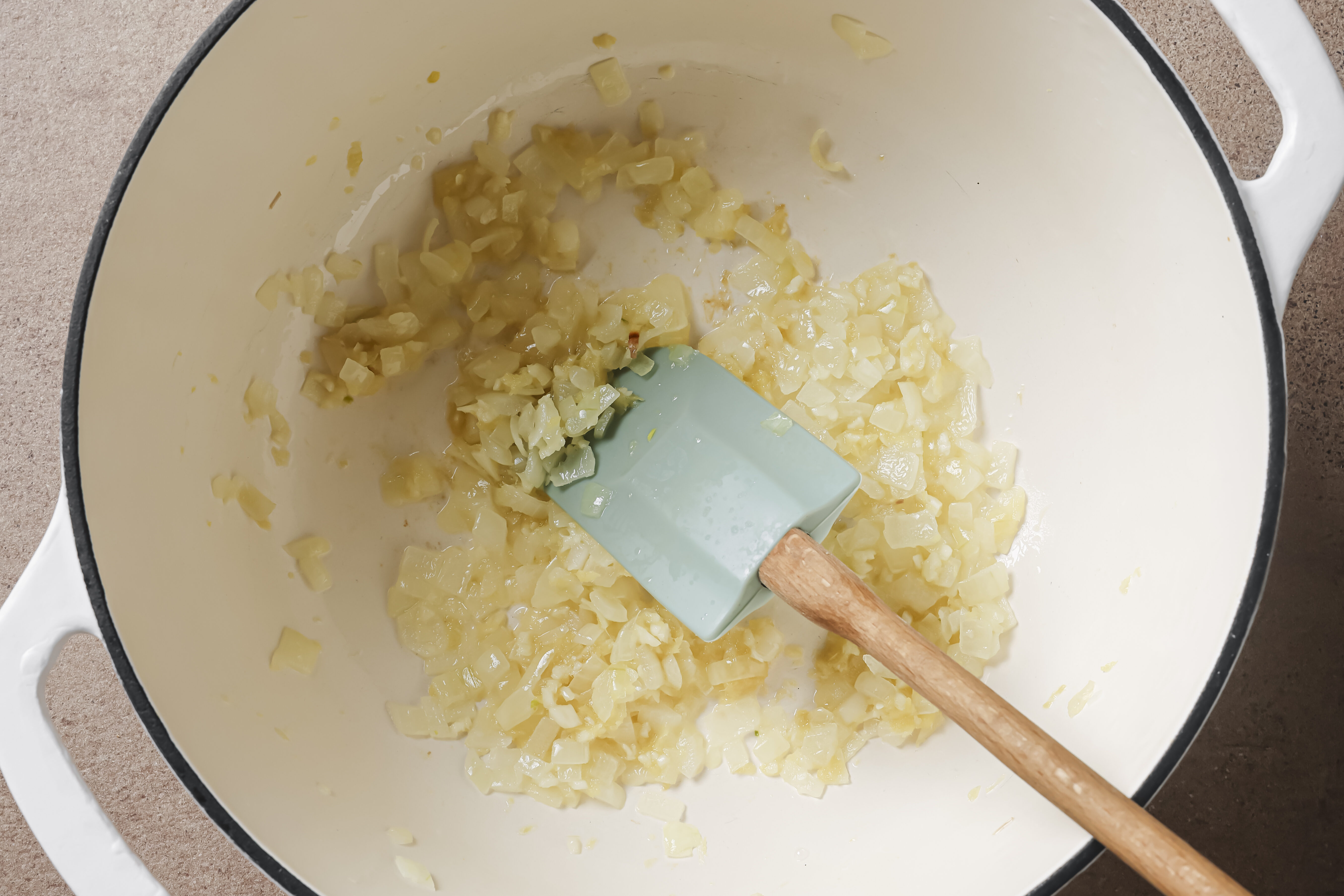 Onion sauteing in a pot.