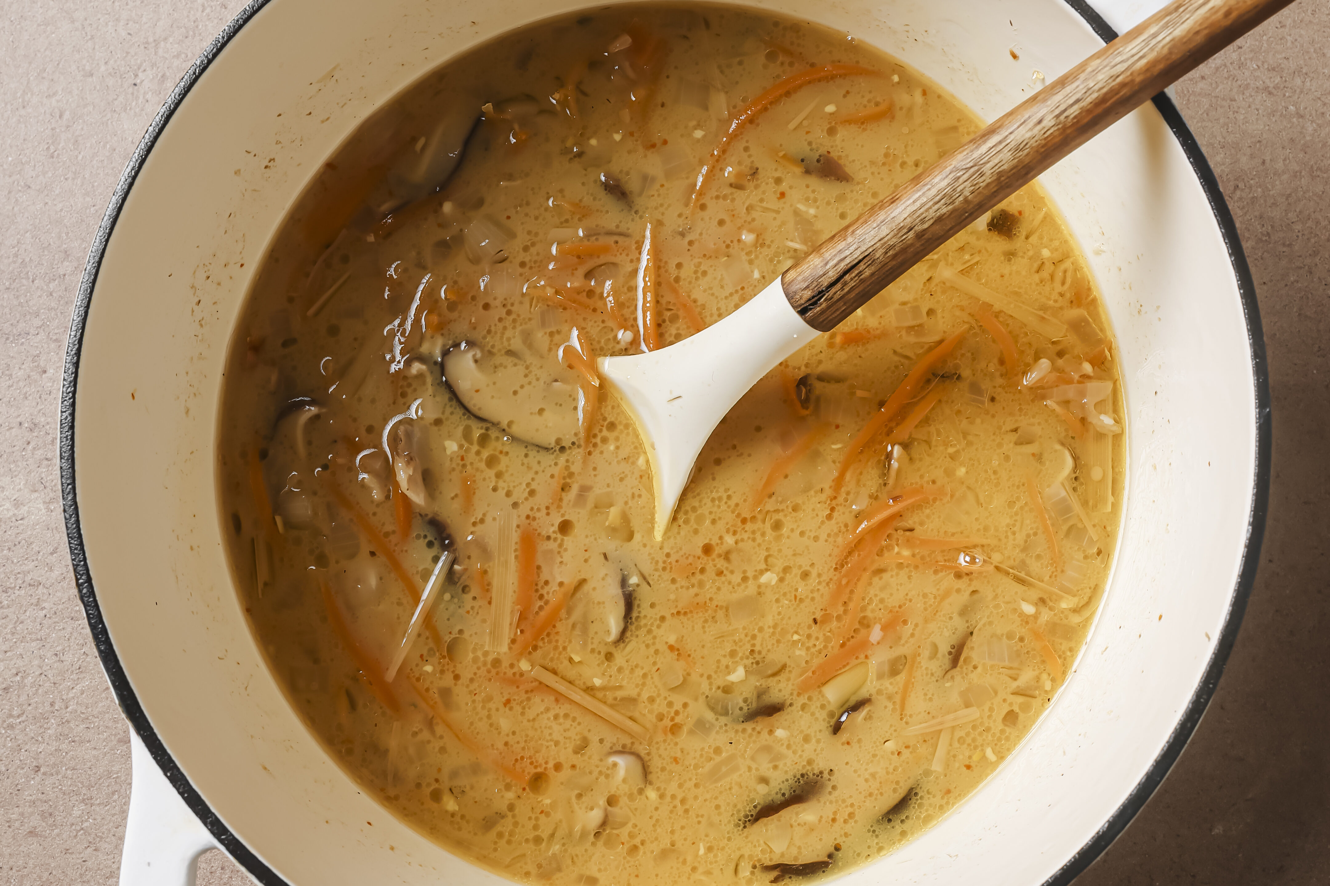 Tom kha soup fully cooked in a pot. 