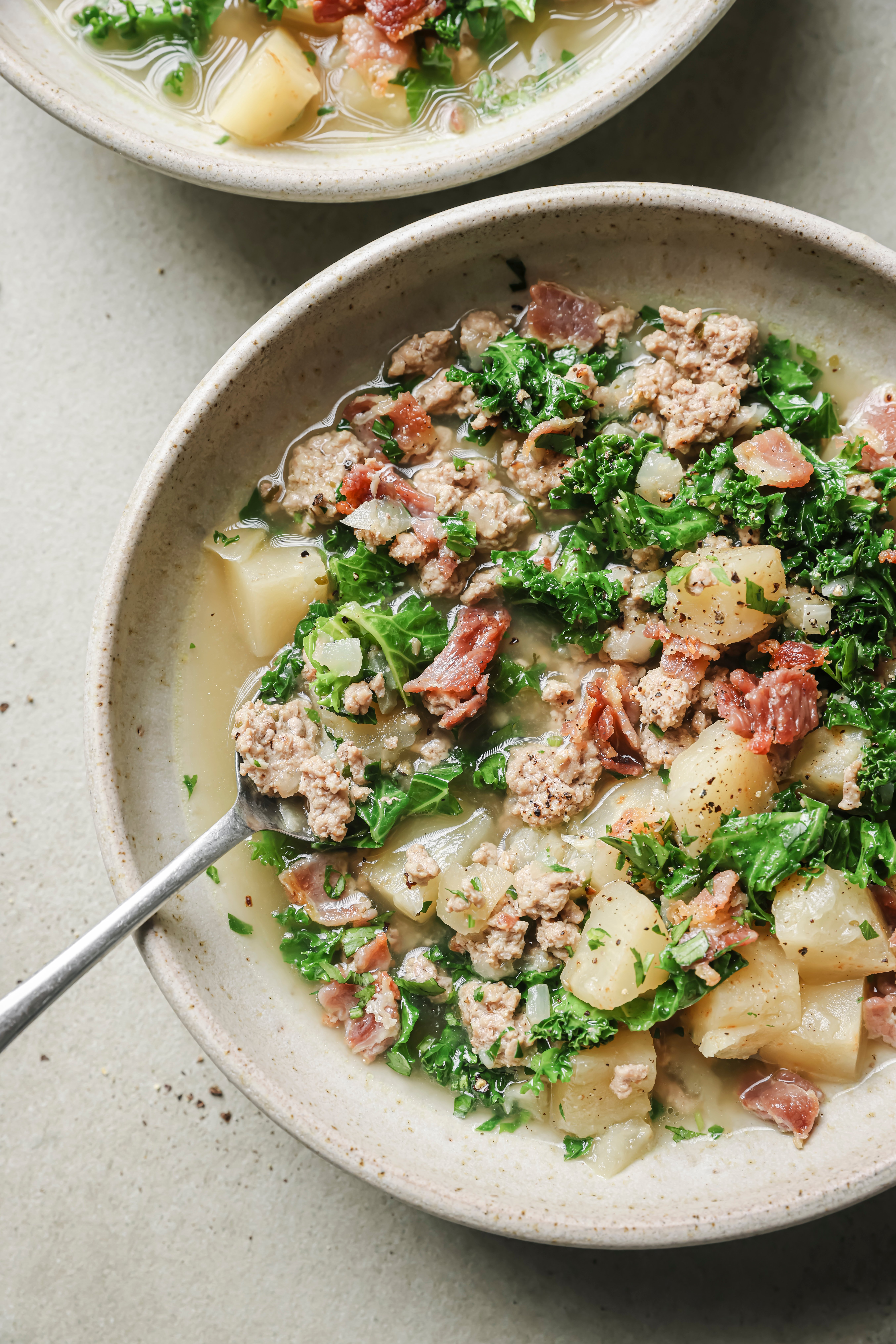 Zuppa toscana in a bowl with a spoon. 
