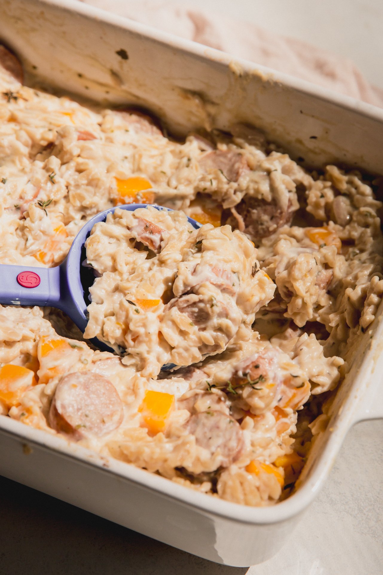 One pan chicken sausage and orzo in a casserole dish. 