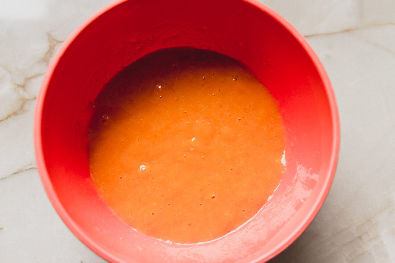 The pumpkin whisked with eggs in a bowl.