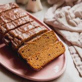 Almond flour pumpkin loaf sliced on a platter .