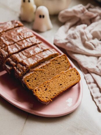 Almond flour pumpkin loaf sliced on a platter .