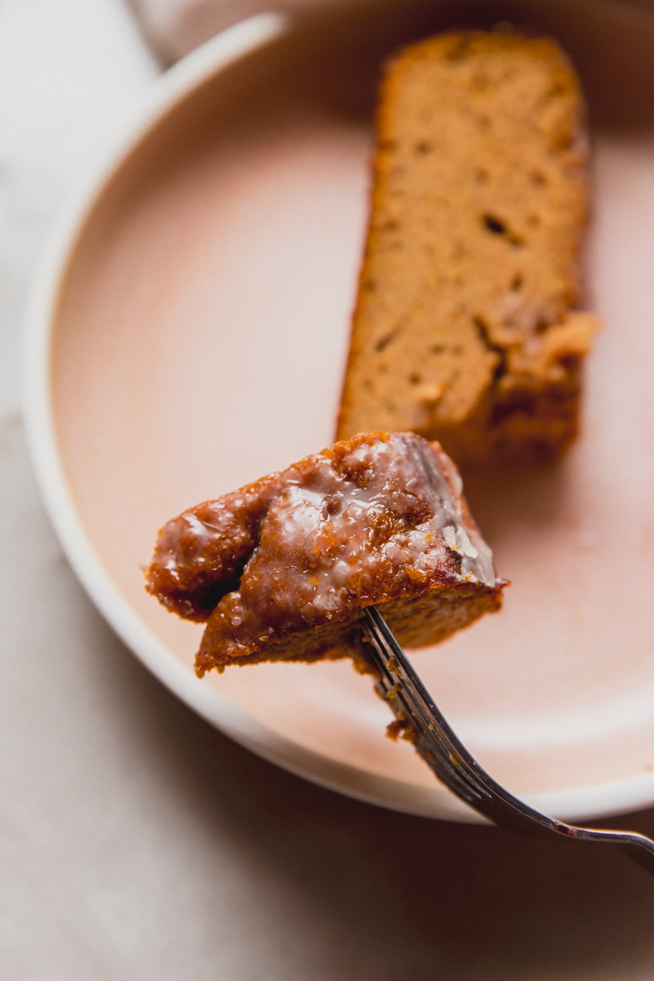 A forkful of almond flour pumpkin loaf taken off a piece and ready to be eaten.