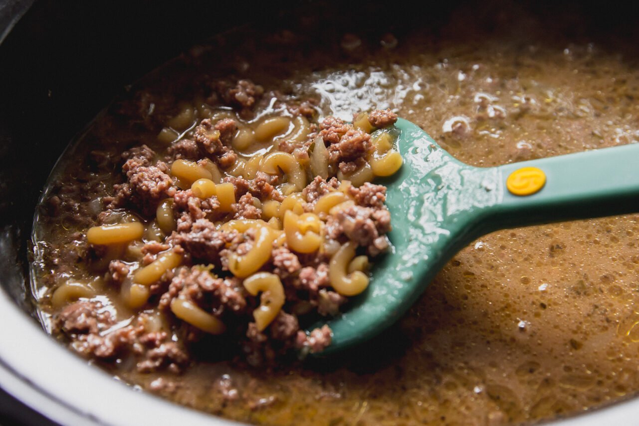 The slow cooker hamburger helper in the slow cooker after adding the dry pasta.