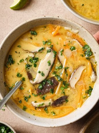 Tom kha soup with a spoon.