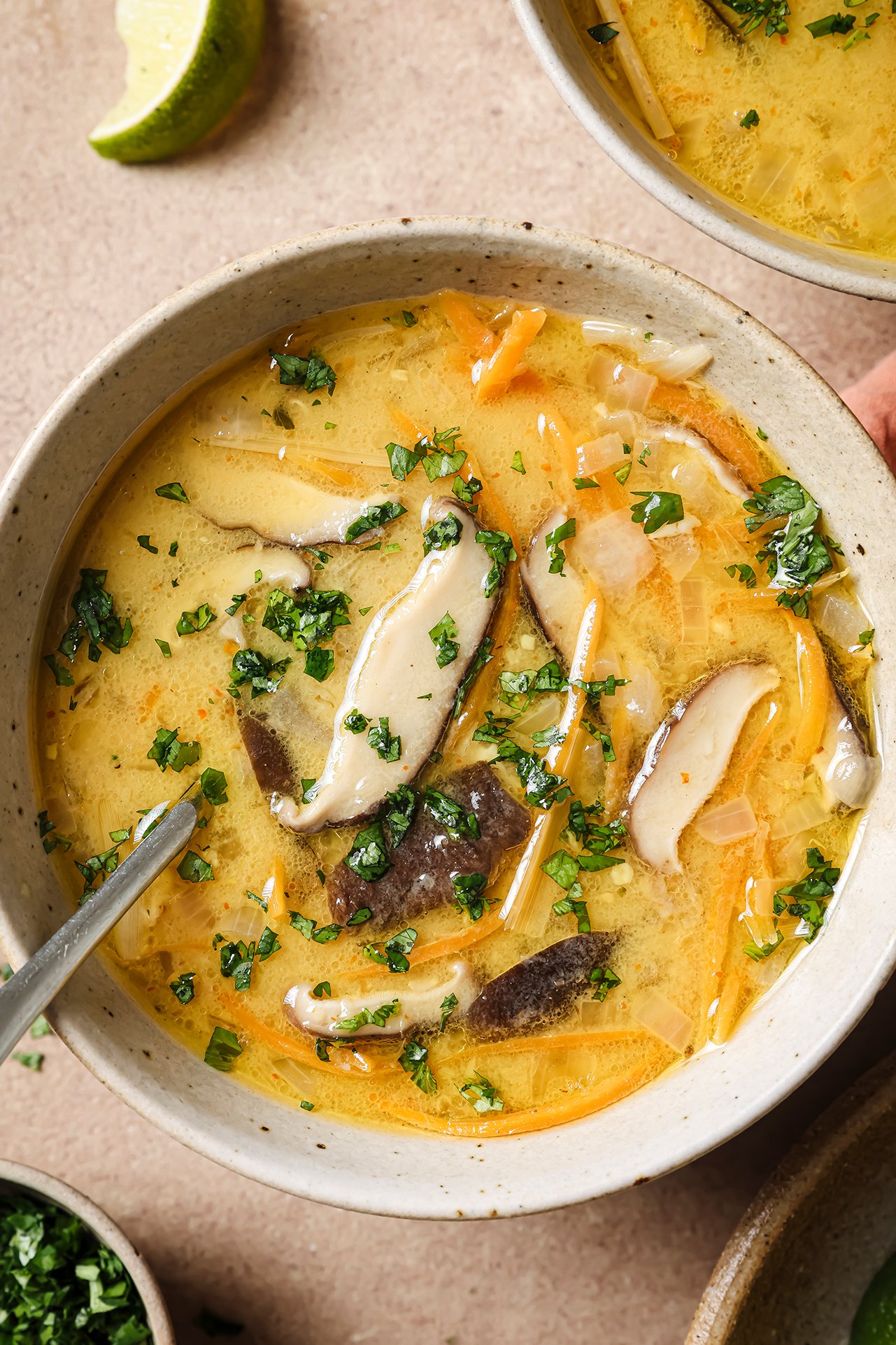 Tom kha soup with a spoon.