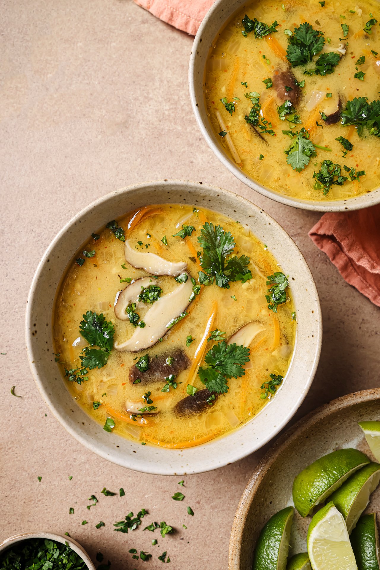 Tom Kha Soup in two bowls topped with cilantro. 