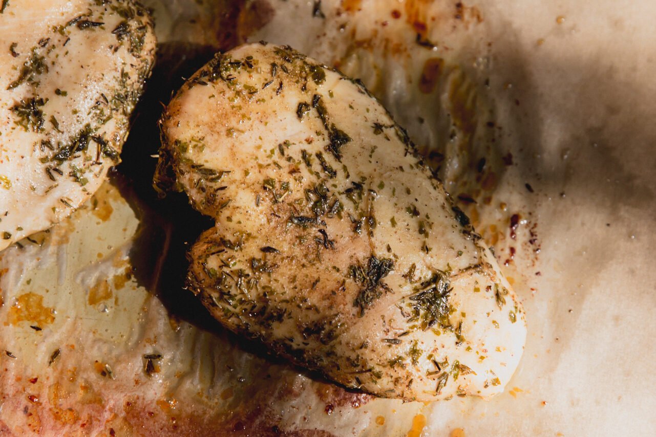 Cooked chicken on a sheet pan.