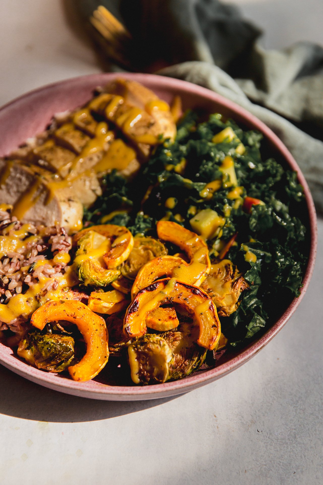 Harvest chicken bowl topped with dressing.