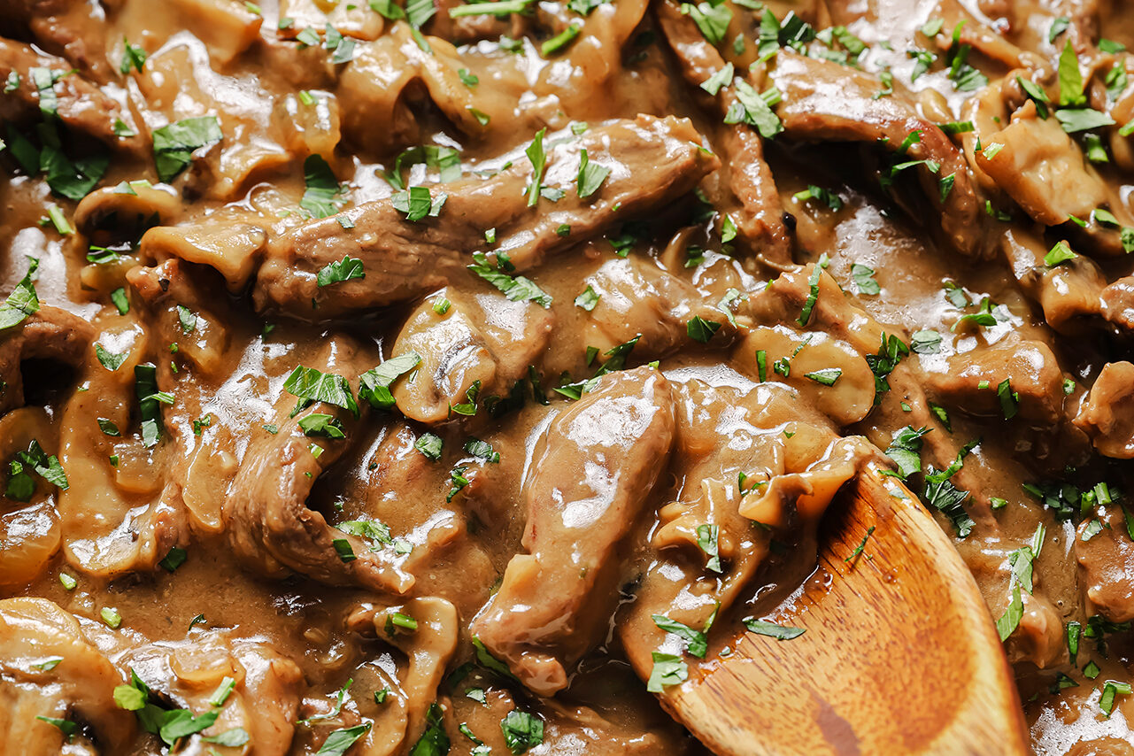 Beef stroganoff with a wooden spoon.