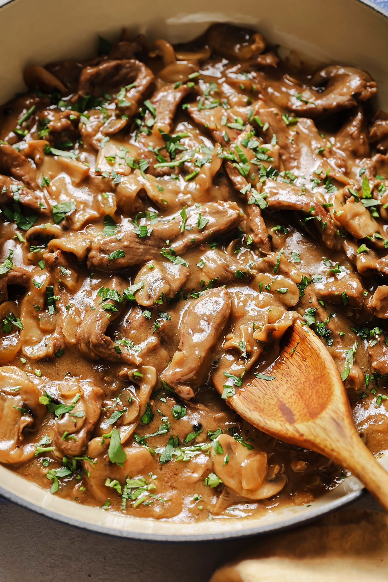 A closeup photo of the beef stroganoff after cooking and topped with parsley.