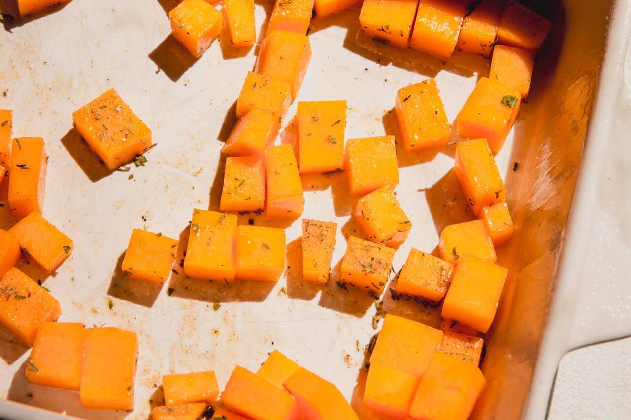 The casserole dish with butternut squash in it.