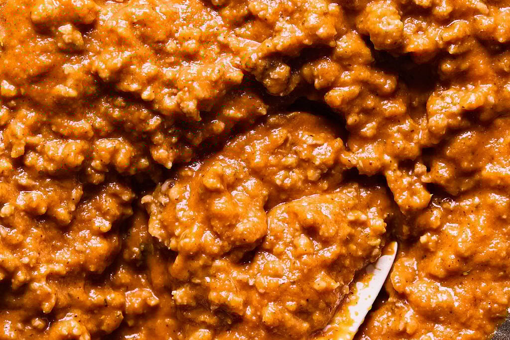 The ground sausage and sauce combined in a bowl.