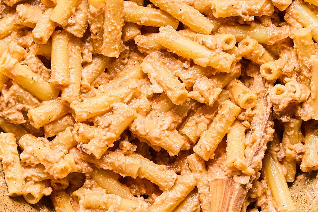 The cooked pasta coated in the cheese mixture.