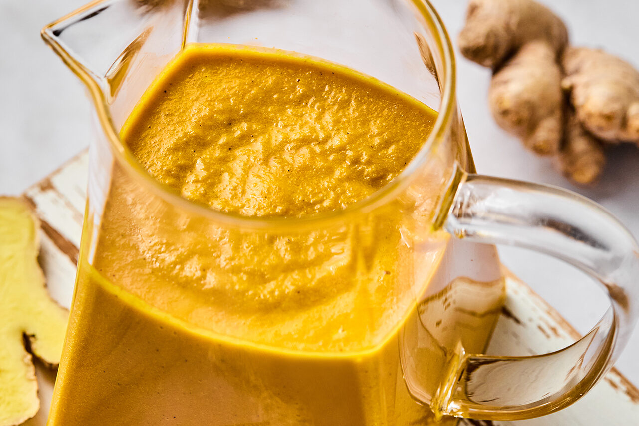 Japanese ginger dressing in a pitcher with fresh ginger on the side.