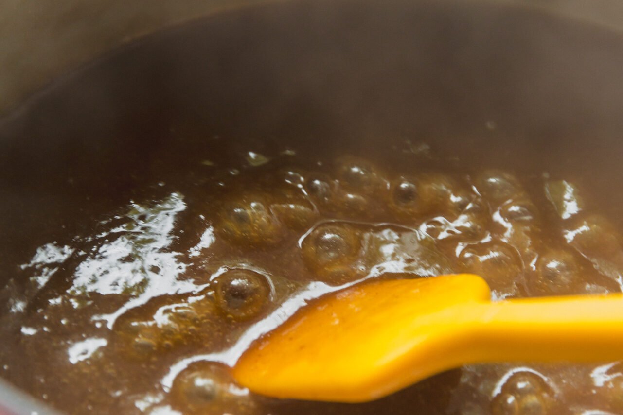 The gravy after thickening simmering on the stove.