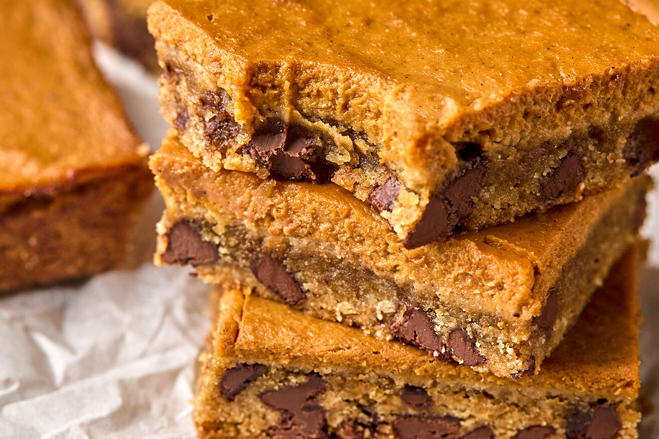 Three pumpkin cookie bars stacked. 