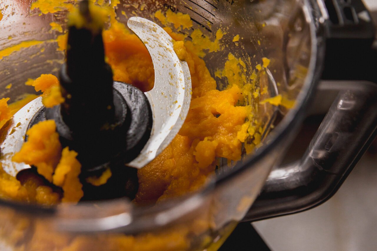 Sugar pumpkin in a food processor being made into puree
