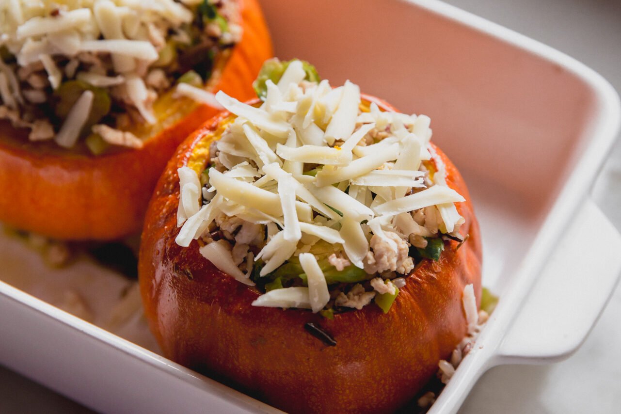 Stuffed pumpkins with shredded cheese.