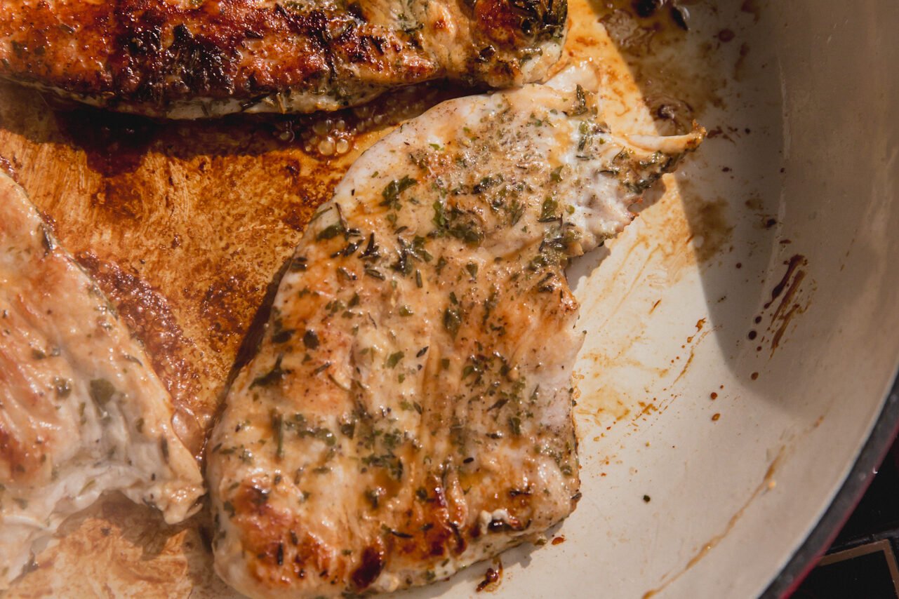 Turkey cutlet cooked in a pan.