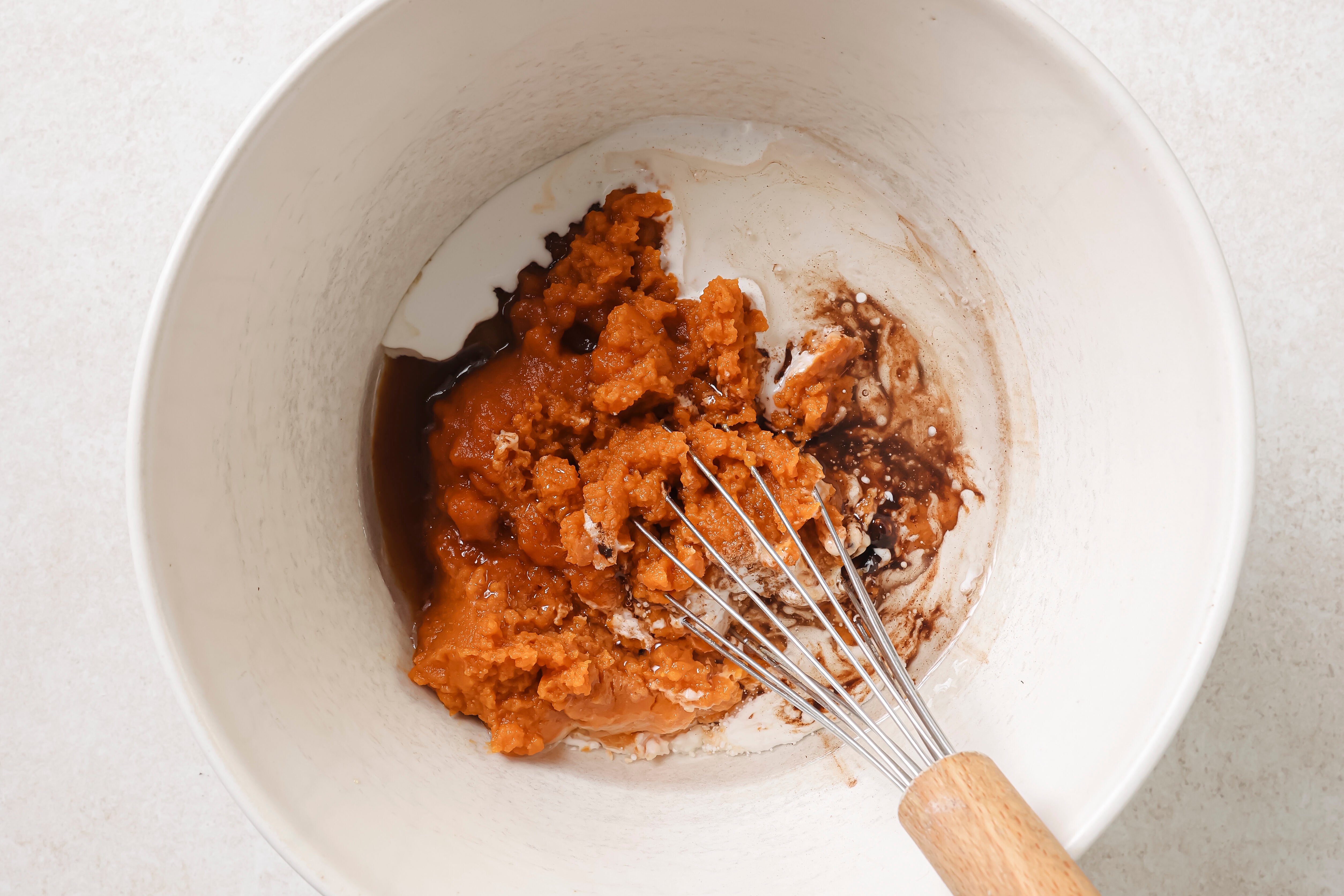 Pumpkin pie bar ingredients for the filling in a bowl, unwhisked. 