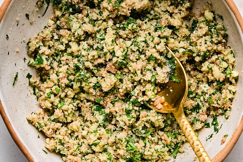 A bowl with the filling mixture to stuff the mushrooms with.