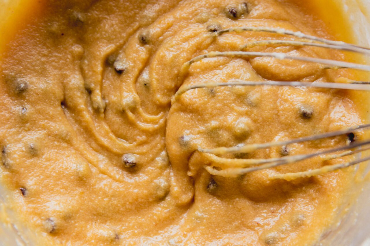 Chocolate chip cookie pie filling whisking in a bowl.