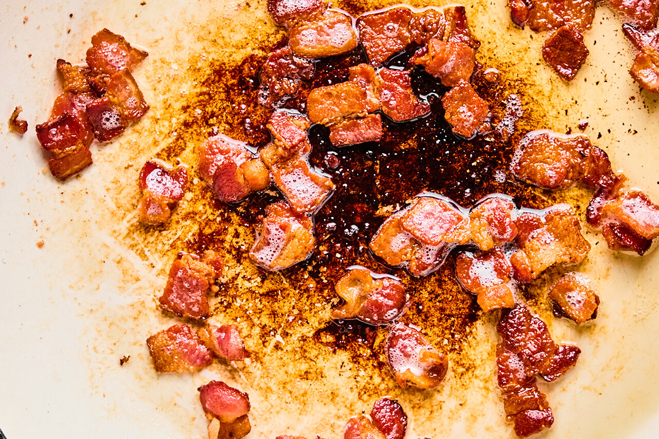 Bacon crisping in a pan.