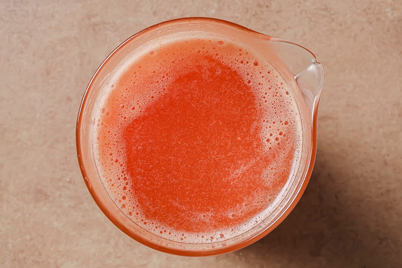 Tomato broth in a glass container.