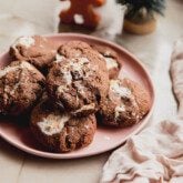 Marhsmallow fluff cookies on a pink plate with mini christmas trees in the background.
