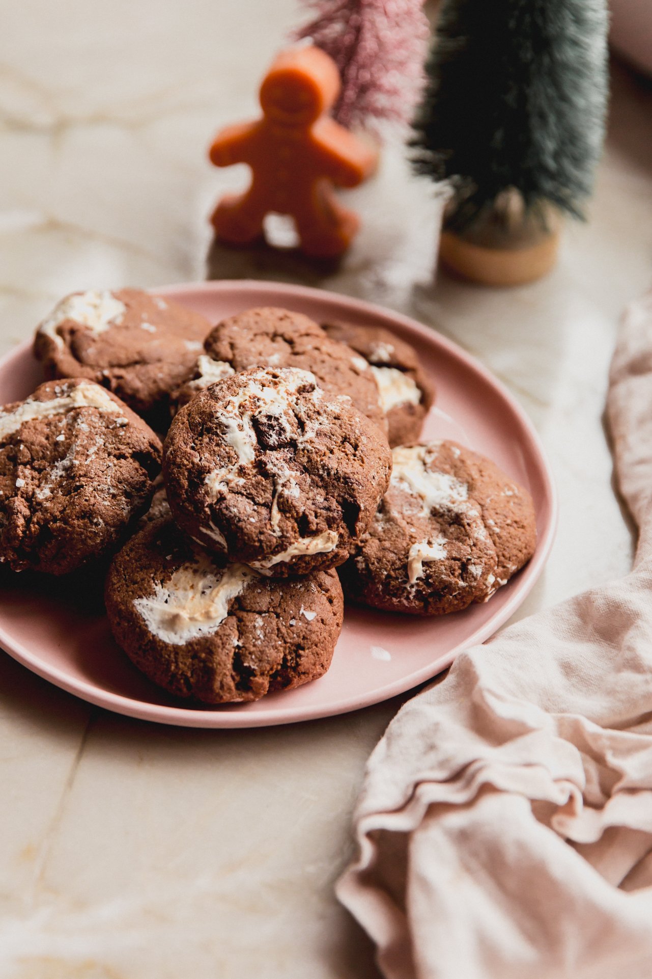 Marhsmallow fluff cookies on a pink plate with mini christmas trees in the background.