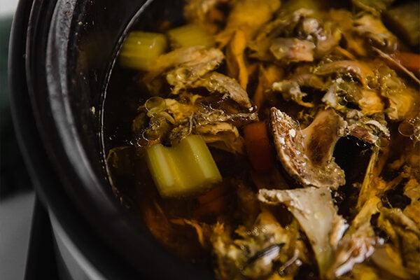 Chicken bone broth cooking in a crockpot