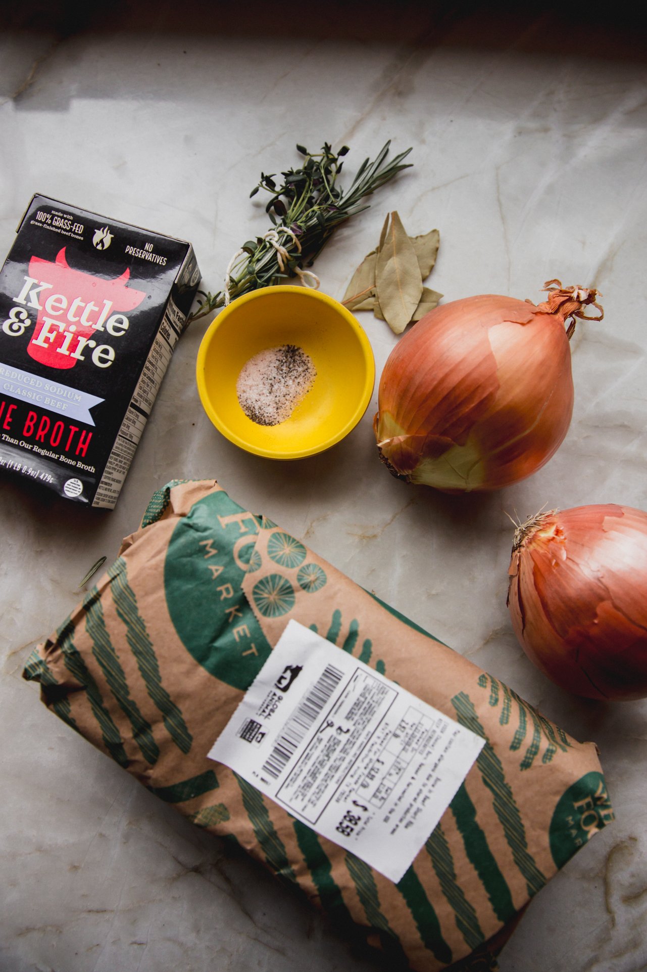 French onion short rib ingredients on a marble counter top.