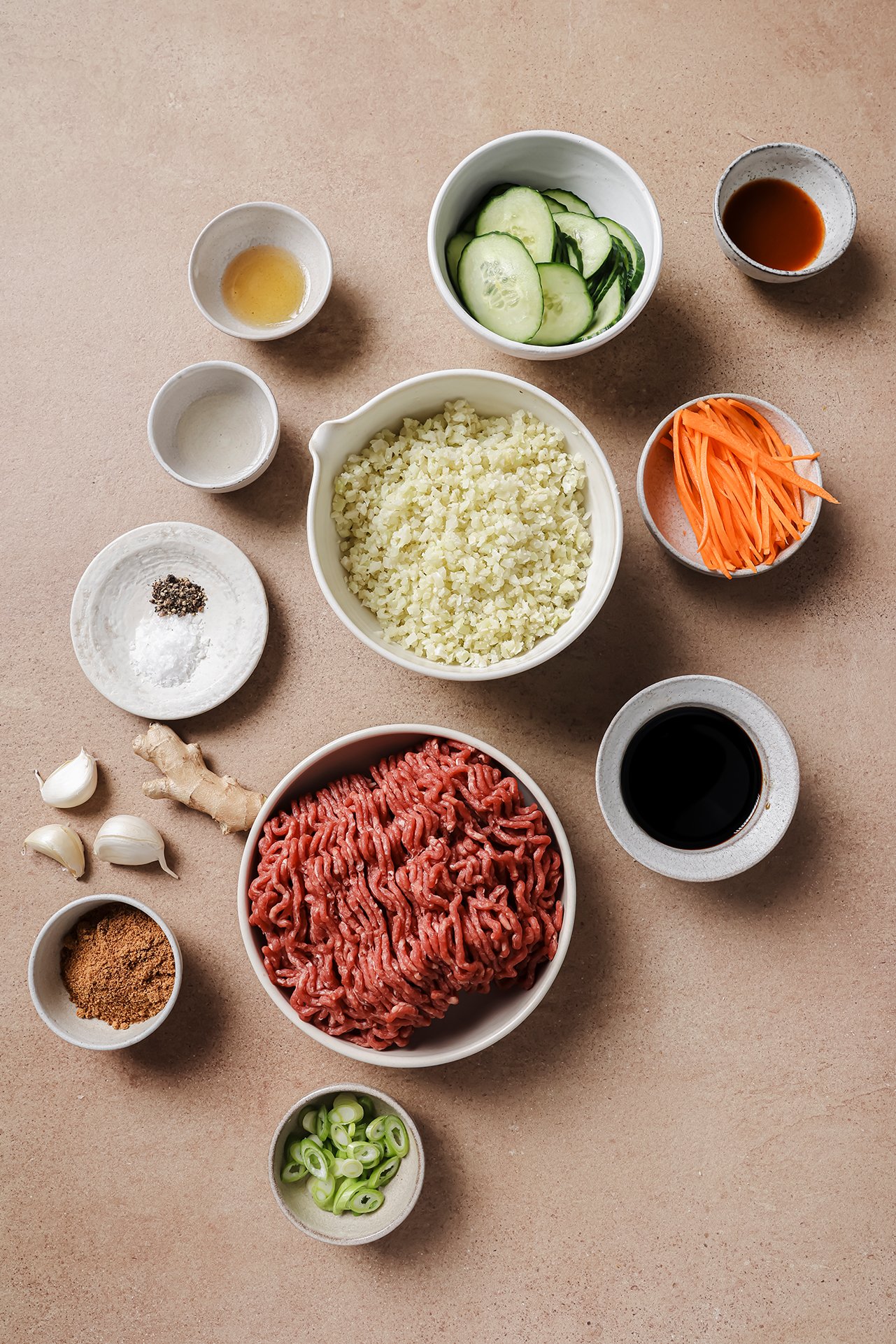 The ingredients needed to make Korean ground beef bowls laid out in bowls before cooking.