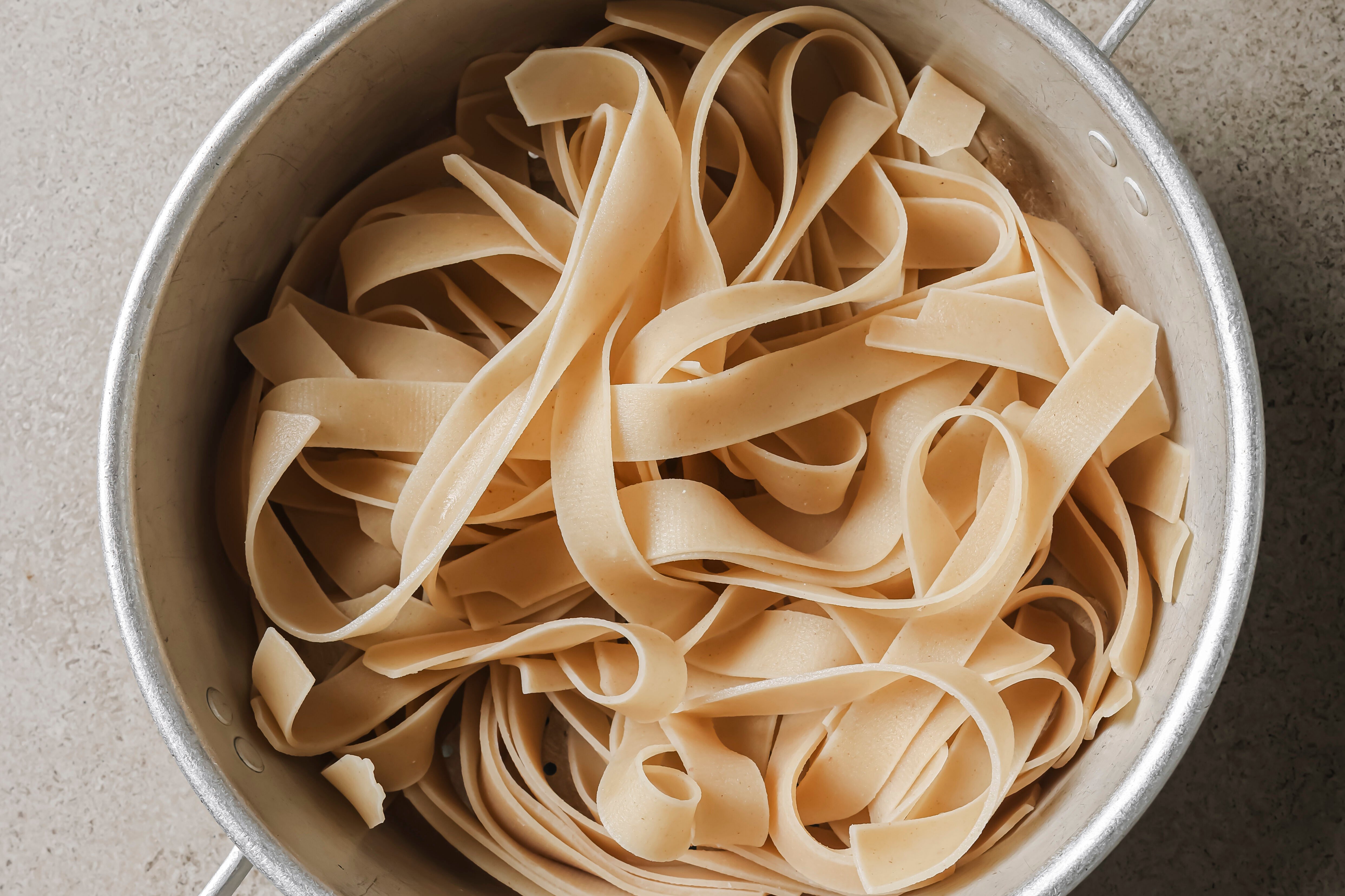 Fully cooked rice noodles in a pot.