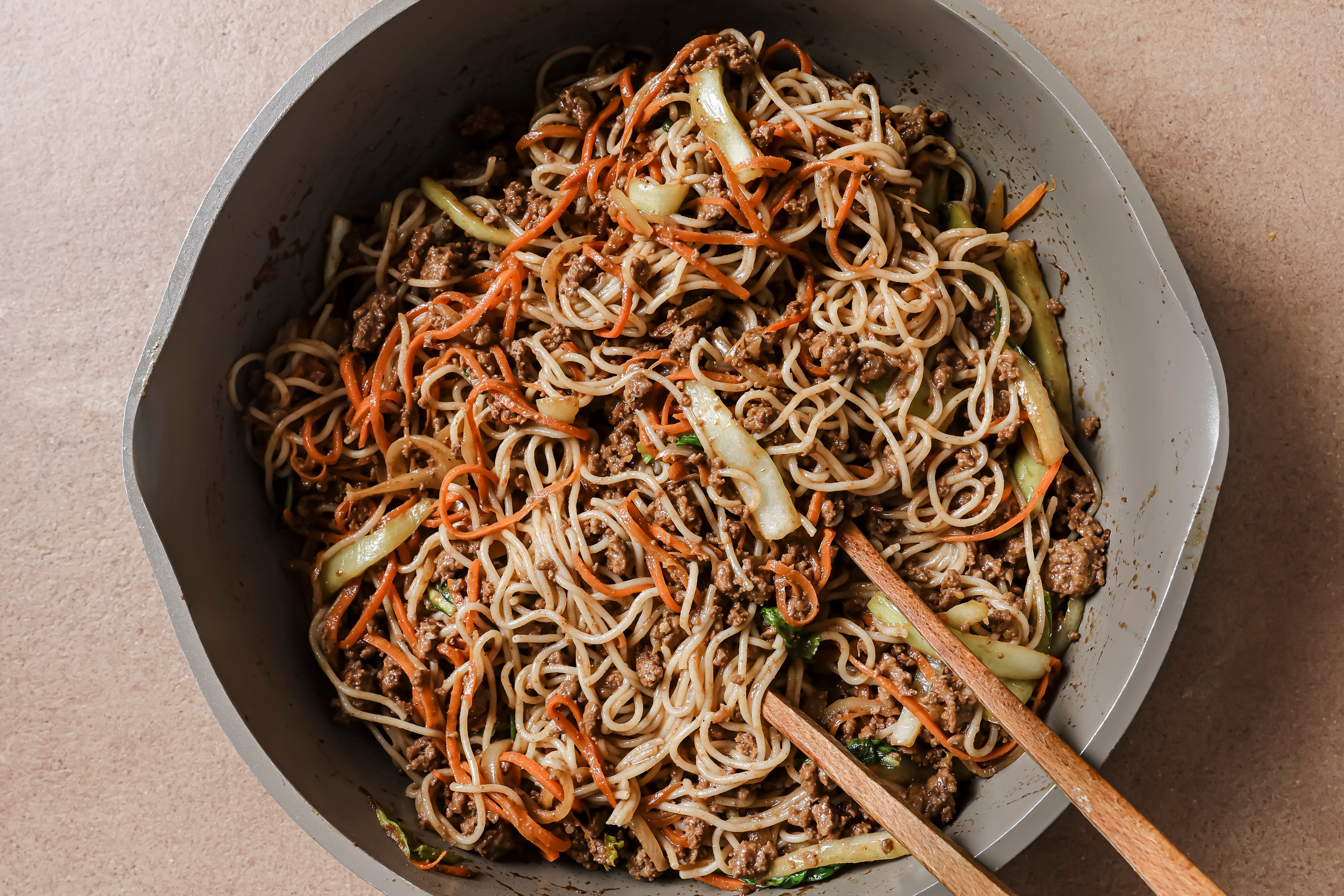 The finished hoisin beef noodles with the sauce, beef, veggies, and noodles after cooking.