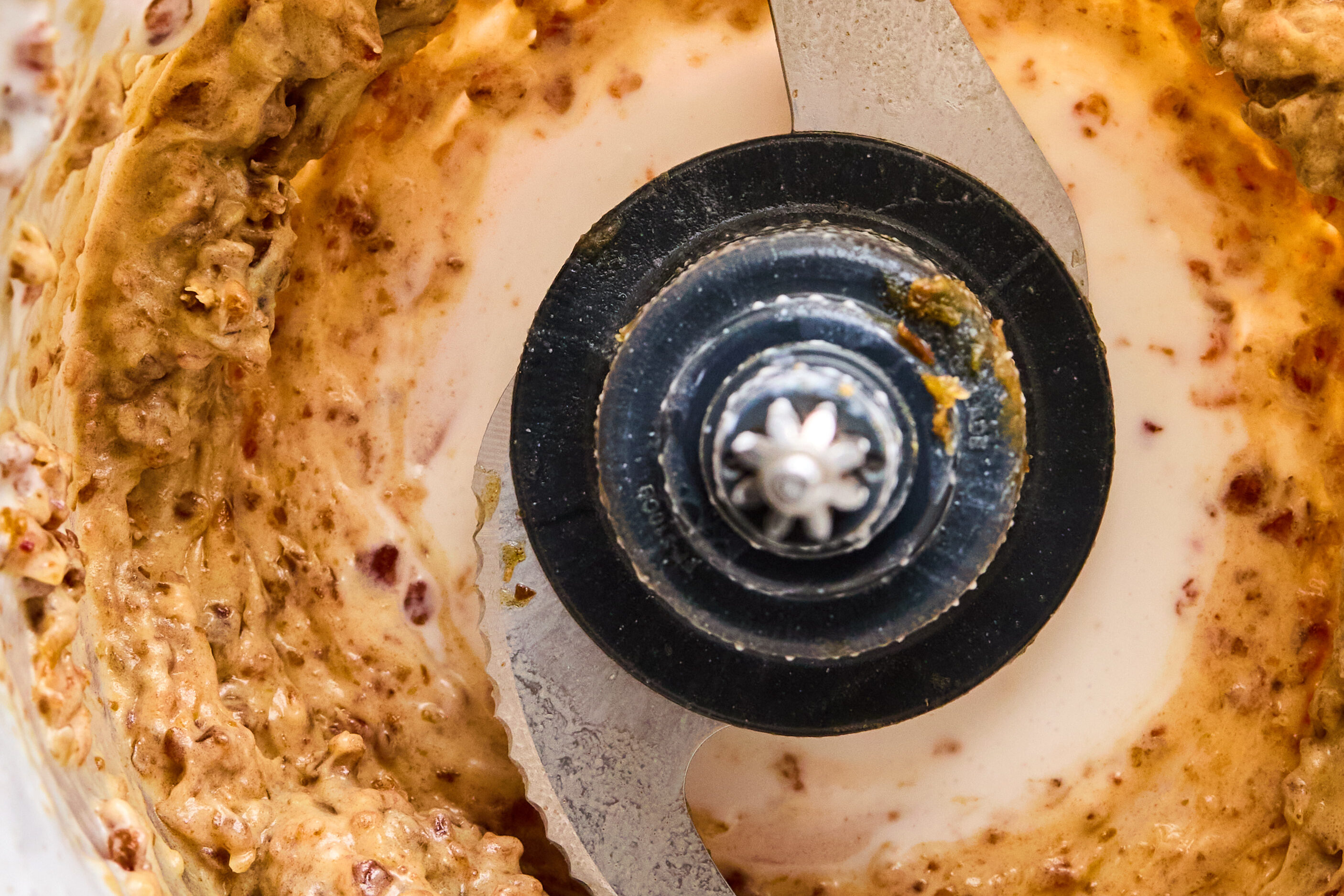 A food processor after mixing dates and coconut milk into a paste.