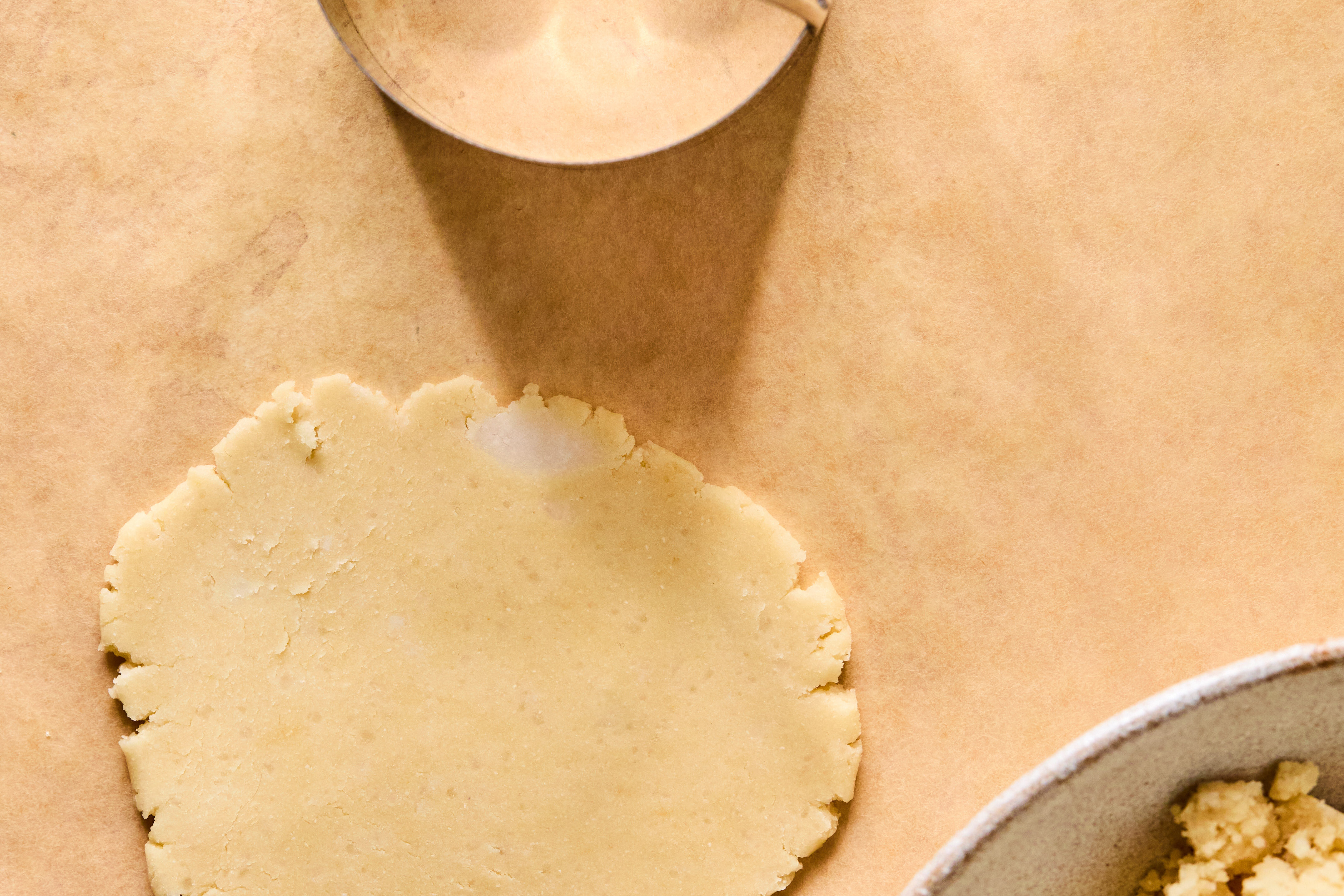 Dough flattened on parchment paper before being cut.