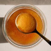 Beef bone broth is a glass jar with a spoon