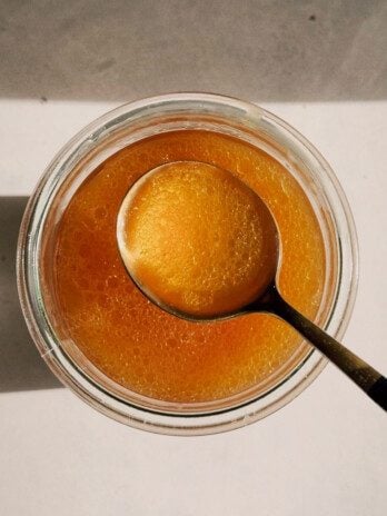 Beef bone broth is a glass jar with a spoon