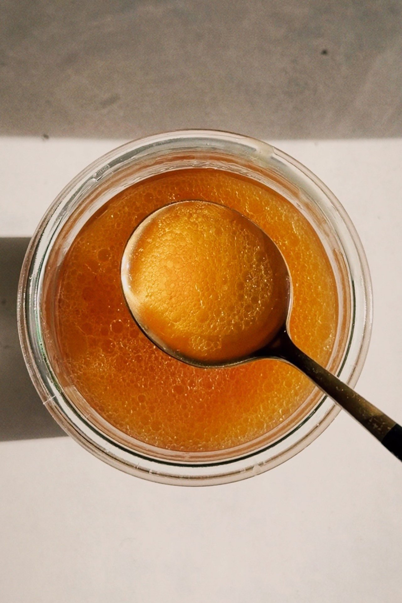 Beef bone broth is a glass jar with a spoon