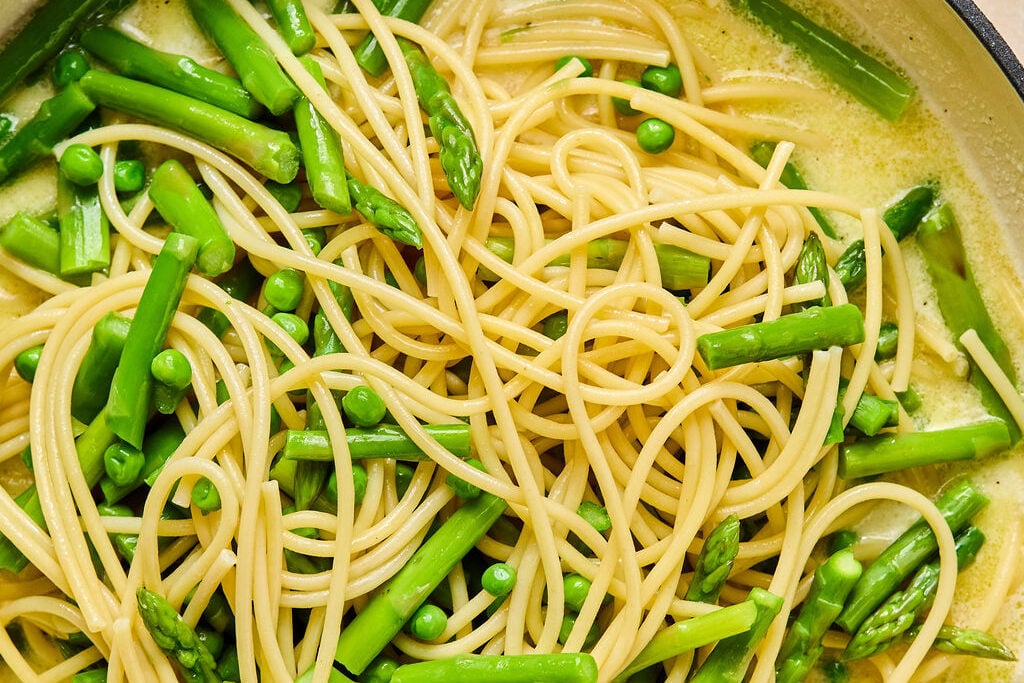 All the ingredients for the lemon goat cheese pasta mixing together in a pan.