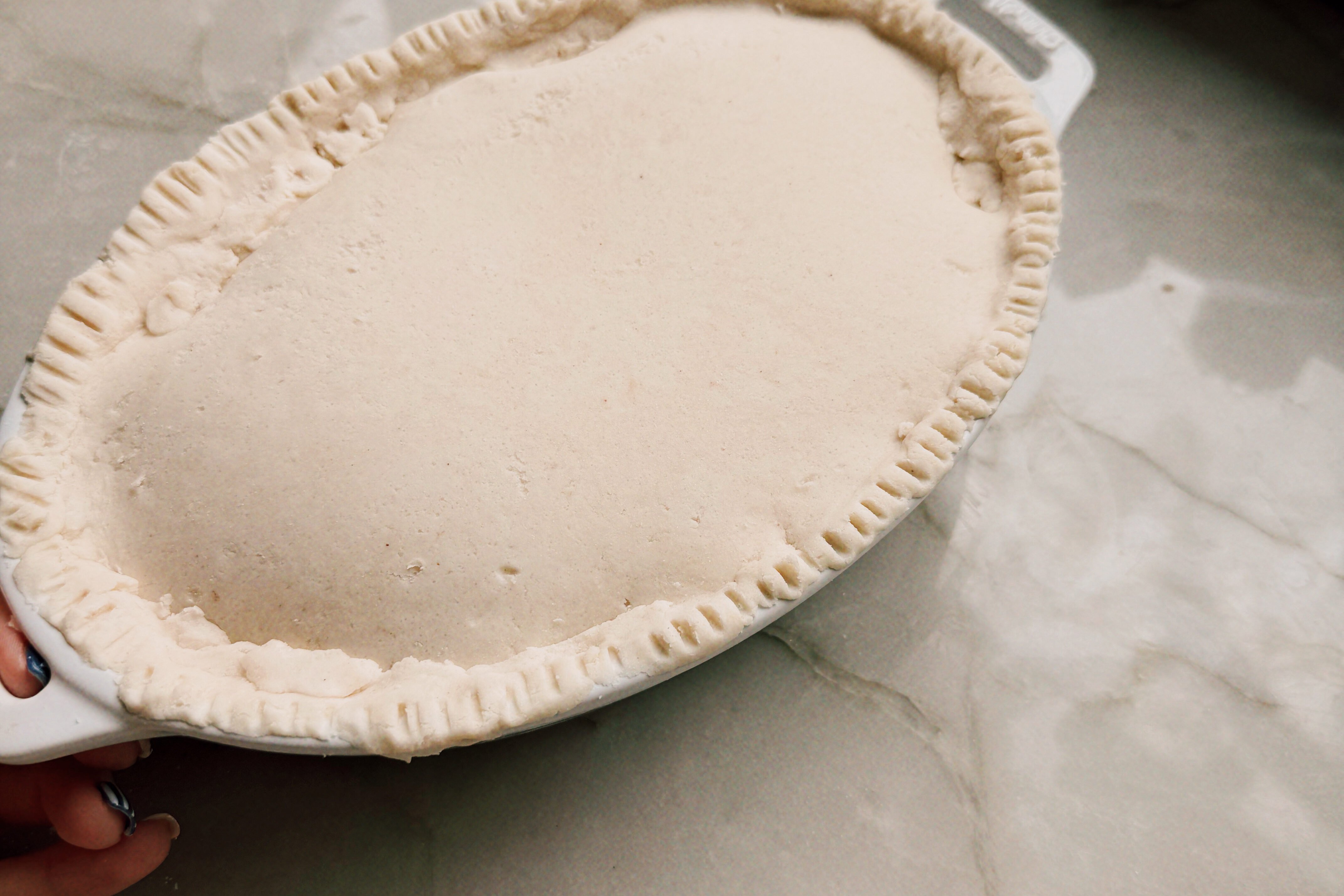 Dough crimped over the beef filling before going into the oven.