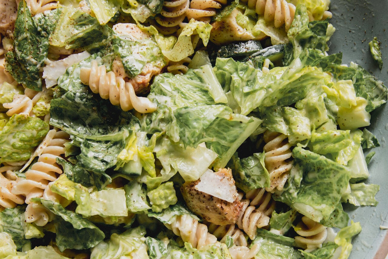 Chicken Caesar pasta salad in a large blue bowl