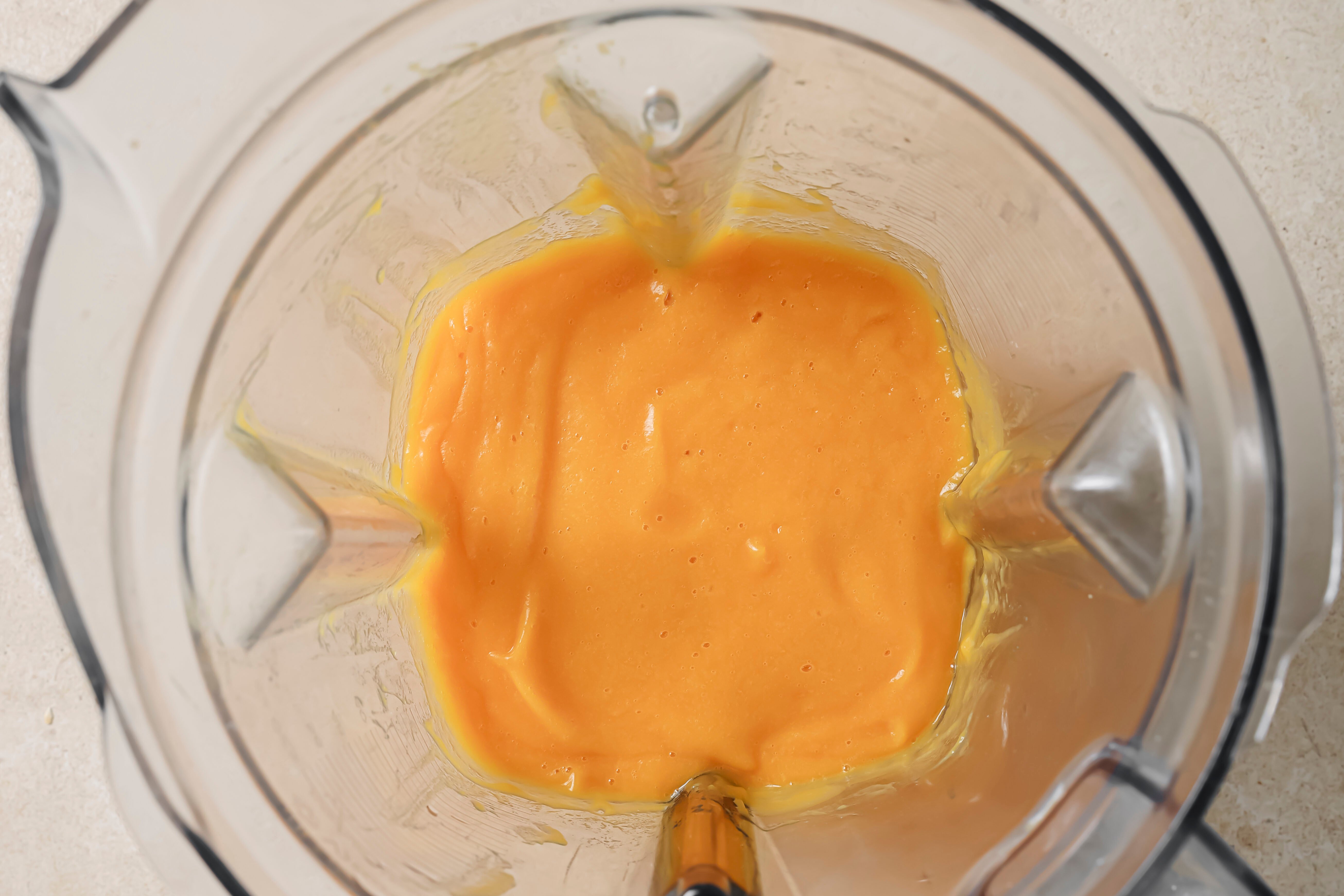 A blender filled with the blended fruits and vegetables.